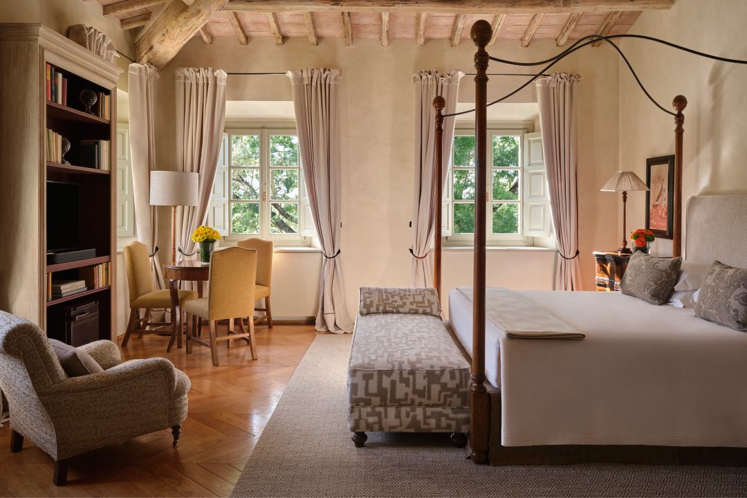 Villa with canopy bed, armchair, dining  table, and large windows